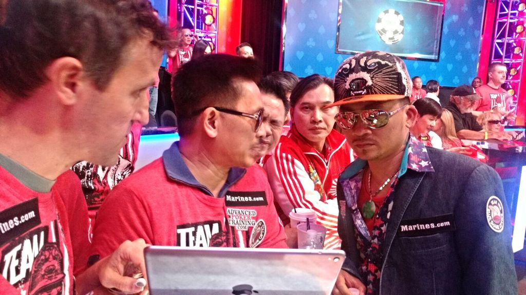 Steve Blay, Young Phan, and TommyGun talk strategy during a break
